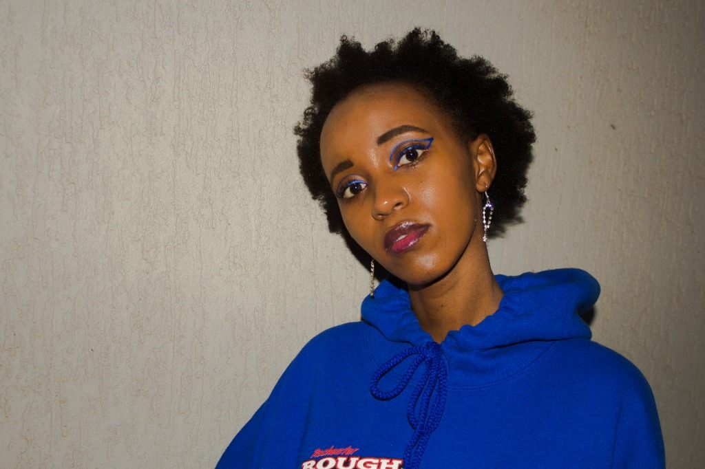 Joy Kathambi close-up portrait blue hoodie