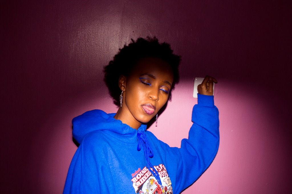 Joy Kathambi blue hoodie purple lighting portrait